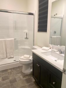 uma casa de banho com um WC, um lavatório e um chuveiro em Private Lux Apartment in a new community em Fontana