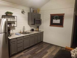 a kitchen with a sink and a refrigerator at Lakefront Cabin - The Willows - 11 in Mead