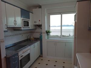 a kitchen with a sink and a window in it at Apartamento en la playa in Laredo