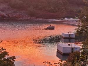 a boat in a body of water at Hilltop Villa Risika in Risika