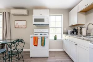 a kitchen with white cabinets and a stove top oven at Plush 1 bed APT near Five Points! Bring your pets! in Columbia