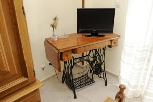 a wooden desk with a computer monitor on top of it at Hostal Ramón y Cajal in Valladolid