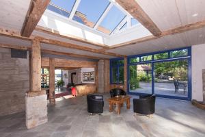 a living room with a vaulted ceiling with skylights at Gästehaus Craintaler Mühle B&B in Creglingen