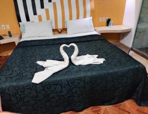 a bed with two white towels on it at Hotel Florencia in Mexico City