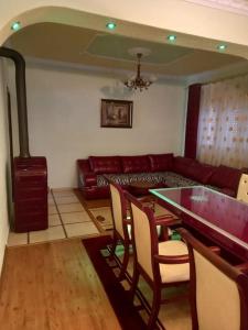 a living room with a table and chairs and a couch at Vila Arapovi - Bosilovo in Strumica