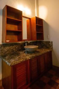 a bathroom counter with a sink and a mirror at Hotel La Calzada in Granada