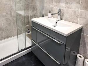 a bathroom with a sink and a shower at The Old Boathouse in Southwell