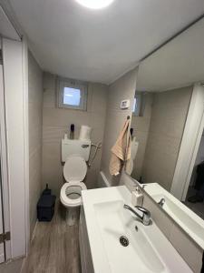 a white bathroom with a toilet and a sink at Magical old city apartment דירת אירוח מקסימה בלב הרובע היהודי in Jerusalem