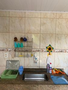 a kitchen counter top with a sink and a counter top at Pousada Korui in Abraão