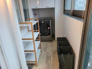 a laundry room with a washer and a washer at Yeongtong Family House in Suwon