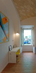 a room with a white desk and a window at Tolli Colosseo Apartment in Rome