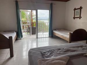 a bedroom with two beds and a view of the ocean at Casa Nostra in Lívingston