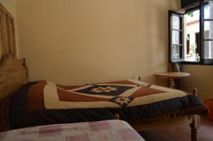 Postel nebo postele na pokoji v ubytování Hostal Coronel Pedro Arraya