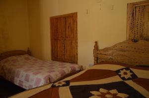 Postel nebo postele na pokoji v ubytování Hostal Coronel Pedro Arraya