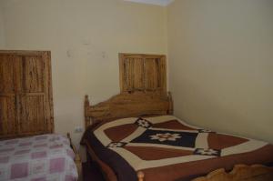 Postel nebo postele na pokoji v ubytování Hostal Coronel Pedro Arraya