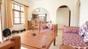 a living room with a couch and a table at Diani Pearl in Diani Beach