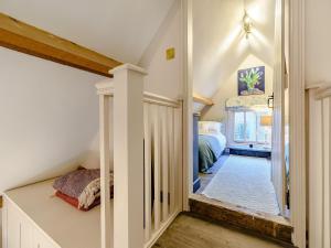 a home with a hallway with a bed and a bedroom at The Barn in Uckfield