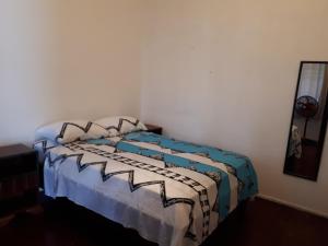 a bedroom with a bed with a comforter and pillows at Adorable 2-bedroom stay with Balcony in Almirante