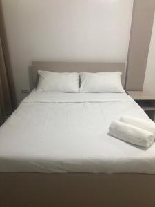 a white bed with two white pillows on it at Francisco Resort in Panglao