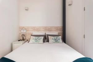 מיטה או מיטות בחדר ב-Neptuno Boutique Apartment - No coração do centro de Aveiro
