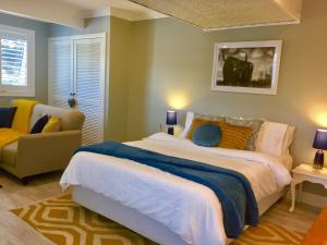 a bedroom with a large bed and a couch at Hamptons In Rye Studio - 3 Mins from Famous Hot Springs! in Rye