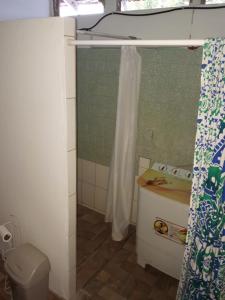 a bathroom with a toilet and a shower curtain at Adorable 2-bedroom stay with Balcony in Almirante