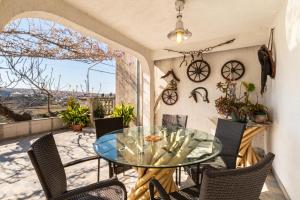 a dining room with a glass table and chairs at Apartments with parking space Lopar, Rab - 14070 in Lopar