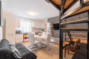 a kitchen and living room with a table and chairs at Apartments with parking space Lopar, Rab - 14070 in Lopar +37 photos