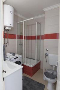 a bathroom with a shower and a toilet and a sink at Apartments with WiFi Split - 20780 in Split