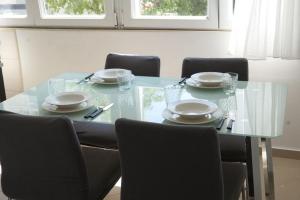 a dining room table with chairs and a glass table top at Apartments with WiFi Split - 20780 in Split