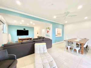 a living room with a couch and a table at Nelson Bay home on the beach!! in Nelson Bay