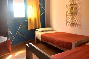 a room with two beds and a window at Hostel Joven casa Reggae in Córdoba