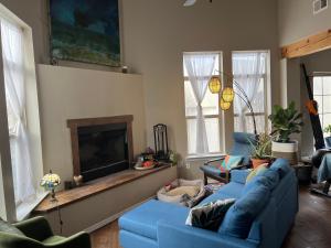 a living room with two blue couches and a fireplace at Santa Fe Charm Home in Santa Fe
