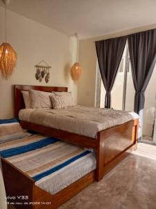 Un pat sau paturi într-o cameră la Villa Kuxtah, Beautiful bungalow with Private Pool
