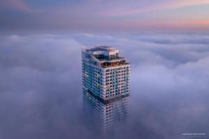 a tall building in the middle of a sea of clouds at Grand Hyams Hotel - Quy Nhon Beach in Quy Nhon