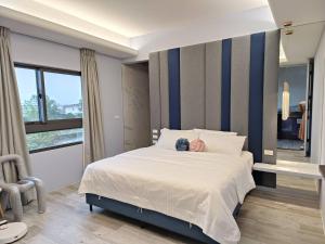 Postel nebo postele na pokoji v ubytování 鴝花甜點民宿 QuHua Sweety B&B