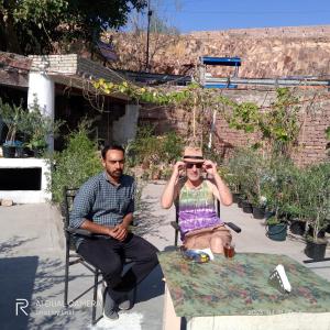 dos hombres sentados en una mesa hablando por celulares en UGS guest house en Jodhpur