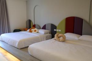 Postel nebo postele na pokoji v ubytování 鴝花甜點民宿 QuHua Sweety B&B