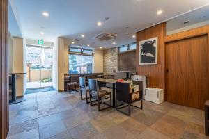 an office lobby with a table and chairs in it at RESI STAY Jisco Hotel Kyoto Goshonishi in Kyoto