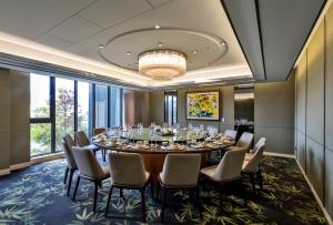 a conference room with a long table and chairs at Hsin Hotel in Chiayi City
