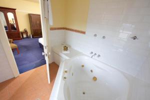 a white bath tub in a bathroom at Carrington Hotel in Katoomba
