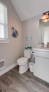 a white bathroom with a toilet and a sink at Clam A Lot in Ocean Shores +31 photos