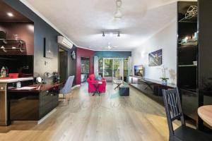 a kitchen and living room with a red chair at ZEN MARKETS - Boutique 1-BR Apt Near Parap Markets in Paraparap