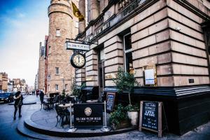 a building with a clock on the side of it at The Inn on the Mile in Edinburgh