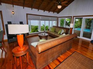 a living room with a couch and a television at Top Ridge Views - 2 Bedrooms in Sandy Bay