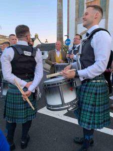 a group of men in kilts playing drums at Cosy cottage flat in Inveraray