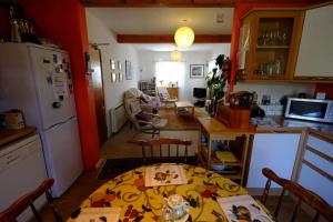 a kitchen with a table and a kitchen with a refrigerator at Cosy cottage flat in Inveraray