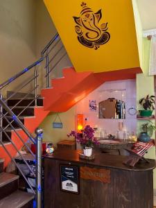 a room with a staircase and a counter with a sink at Ganga Vatika Boutique Hotel, Rishikesh in Rishīkesh