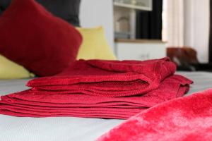 a pile of red towels sitting on top of a bed at 4 on Verbena in Boksburg