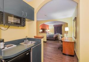 a hotel room with a kitchen and a living room at MY HOME & SUITES MADISON GA in Madison